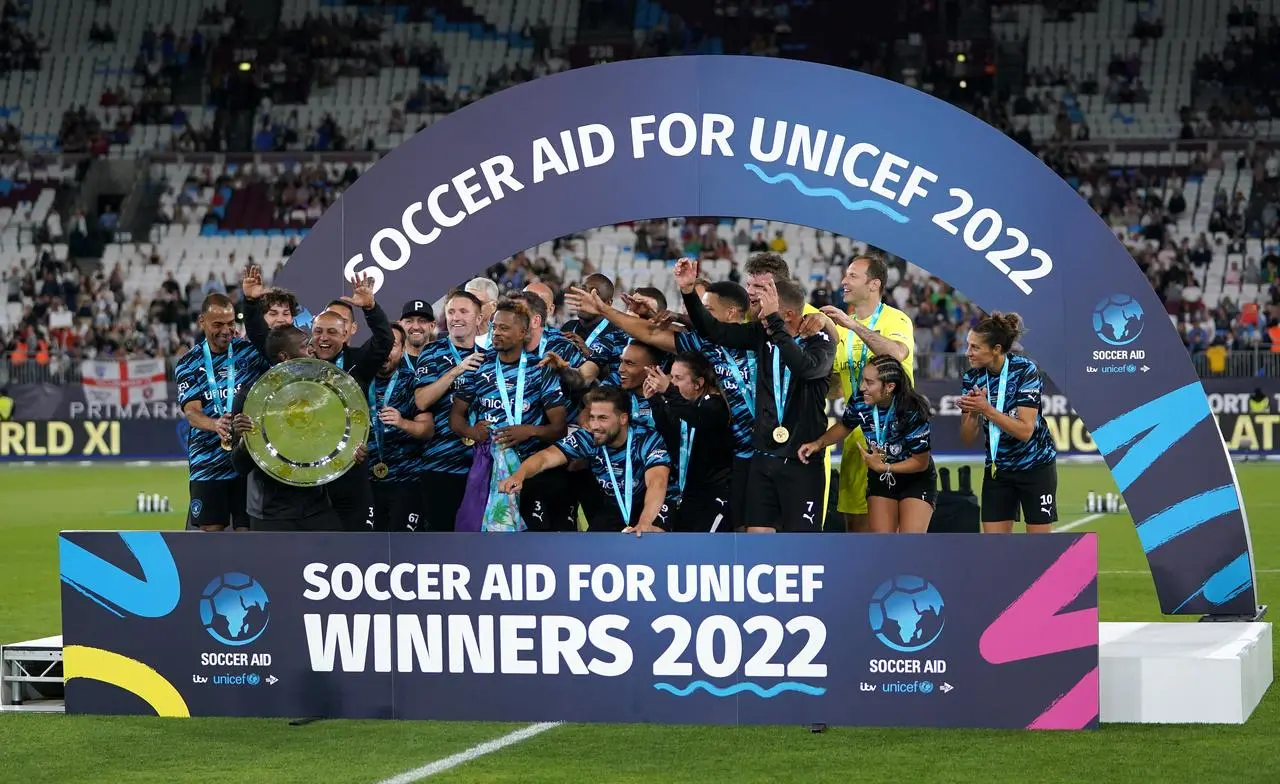 Rest of the World XI players celebrate with the trophy after the Soccer Aid for UNICEF match at The London Stadium