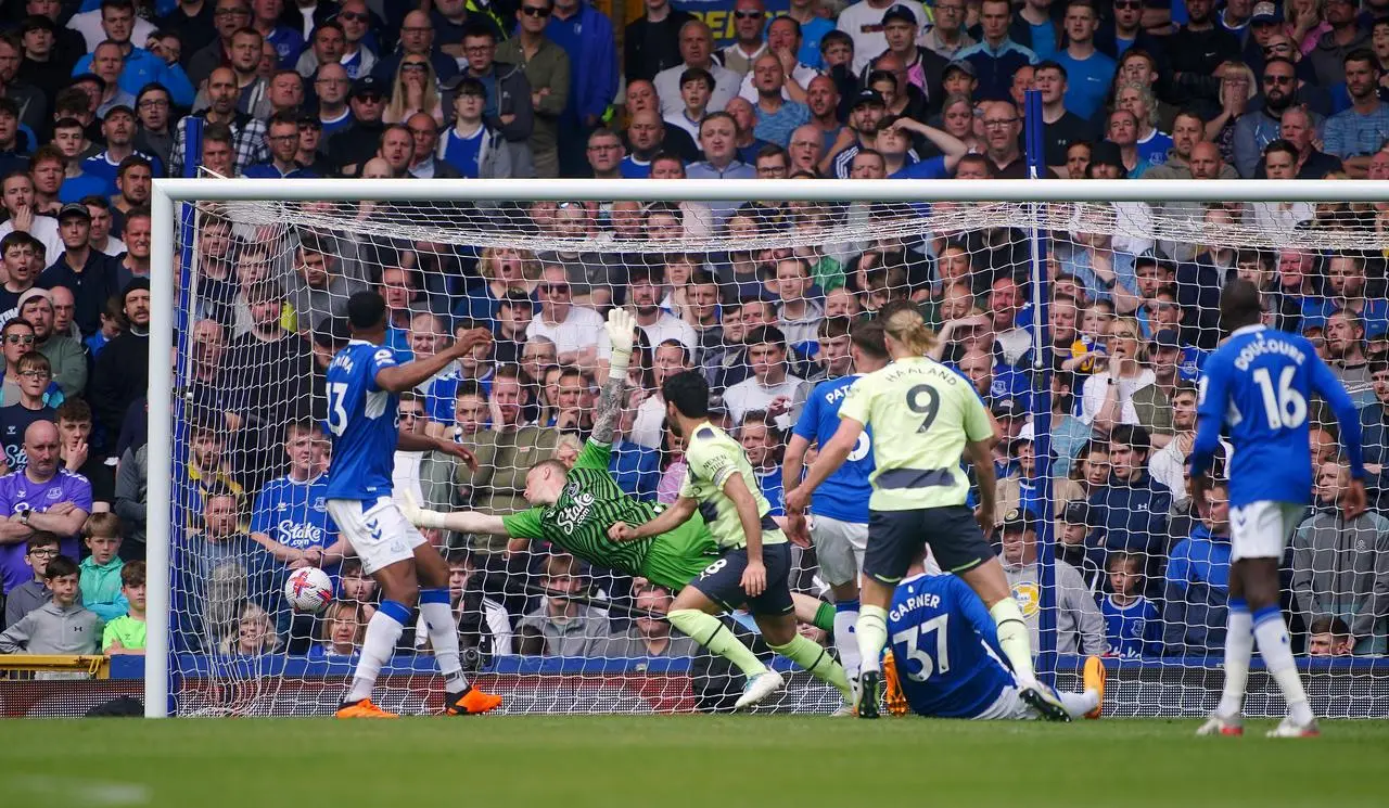 Manchester City’s Ilkay Gundogan scores the first goal of the game despite the best efforts of Everton keeper Jordan Pickford 