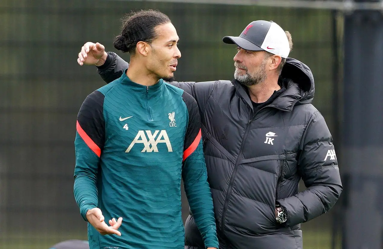 Liverpool defender Virgil Van Dijk (left) has become a key player under Jurgen Klopp (right) 