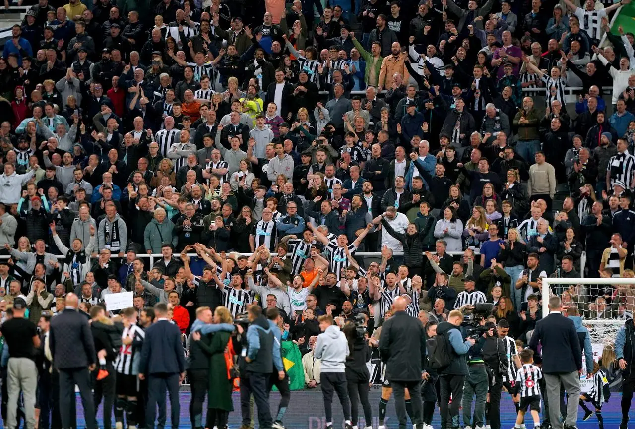 Newcastle fans celebrate at the end of the game 