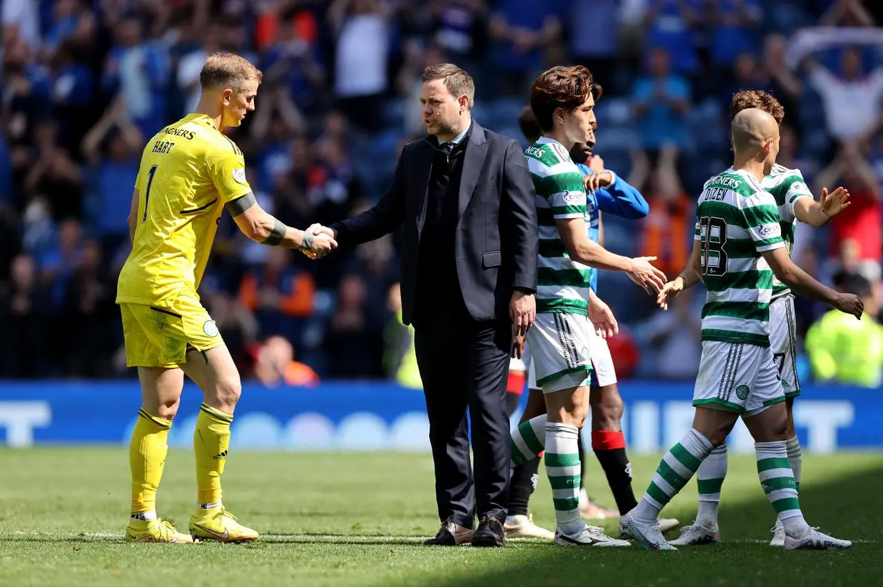 Michael Beale, second left, shakes hands with the Celtic players after the match