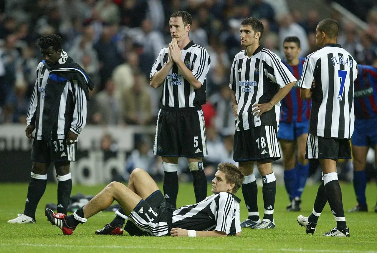 Newcastle’s Jonathan Woodgate (on floor) and his team-mates reflect on their penalty shoot-out defeat by Partizan Belgrade 