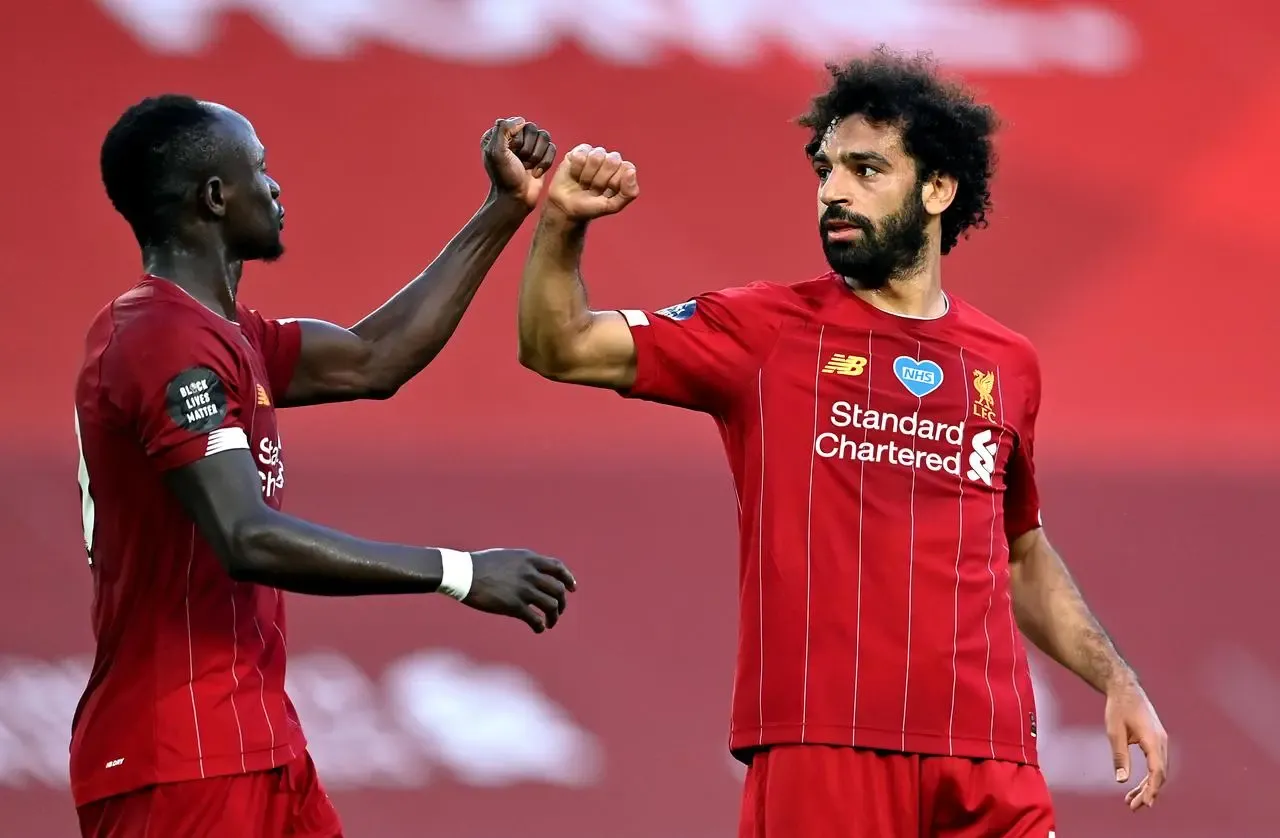 Mohamed Salah, right, celebrates a goal with Sadio Mane