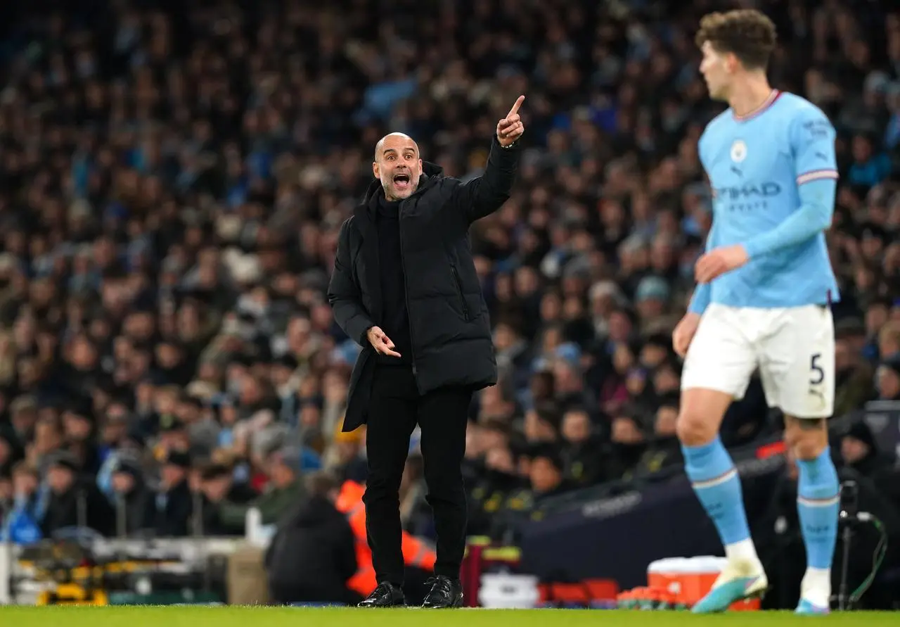 Pep Guardiola gestures to his players