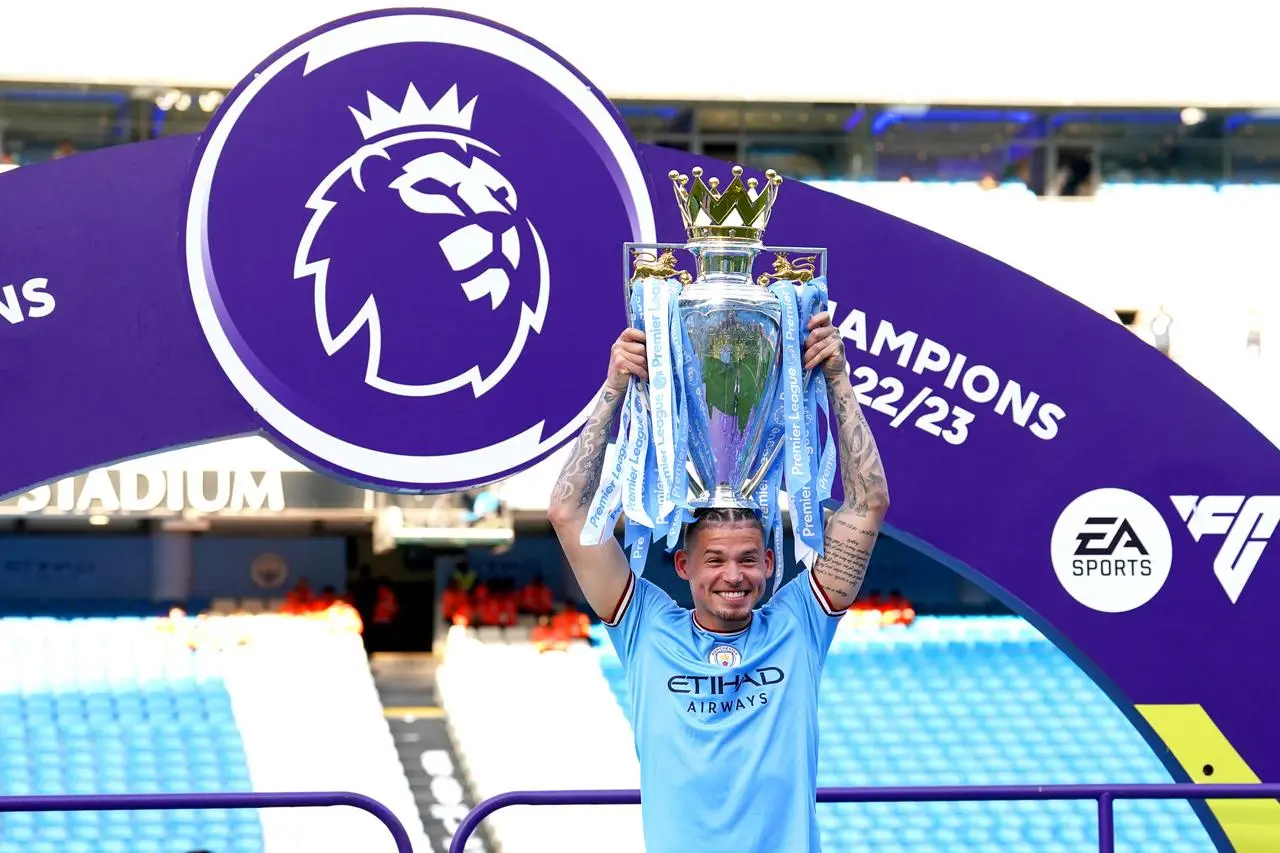 Kalvin Phillips celebrates with the Premier League trophy 