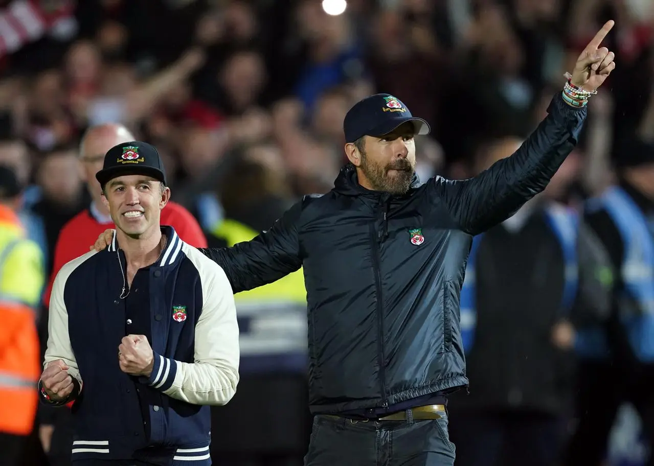 Wrexham co-owners Rob McElhenney and Ryan Reynolds (right) celebrate