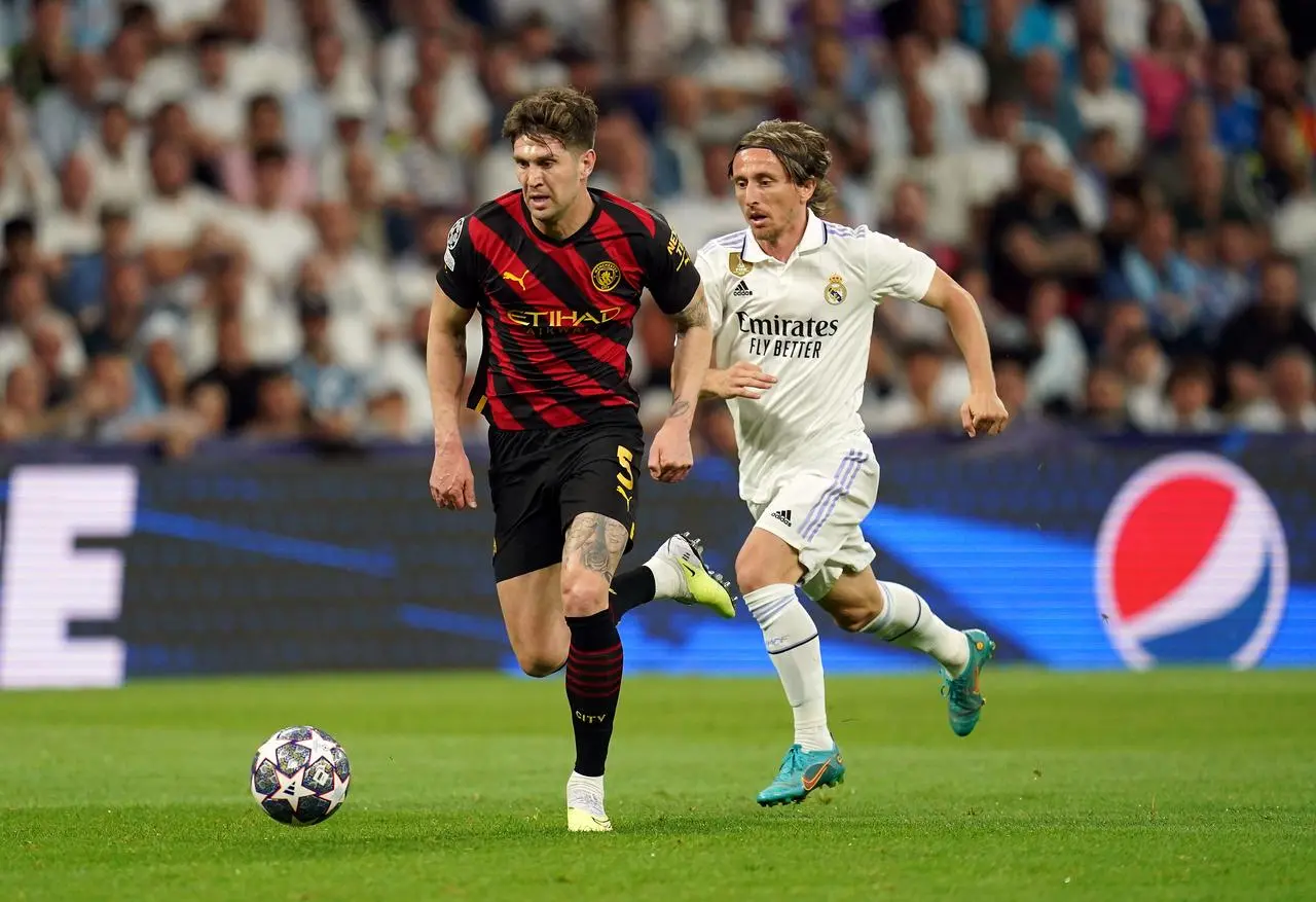 John Stones, left, on the ball against Real Madrid's Luka Modric