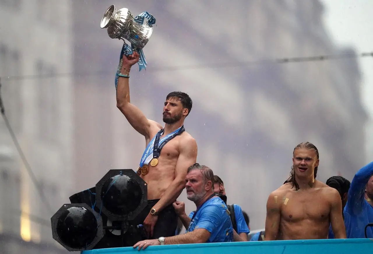 Manchester City’s Ruben Dias and Erling Haaland celebrate during the treble parade