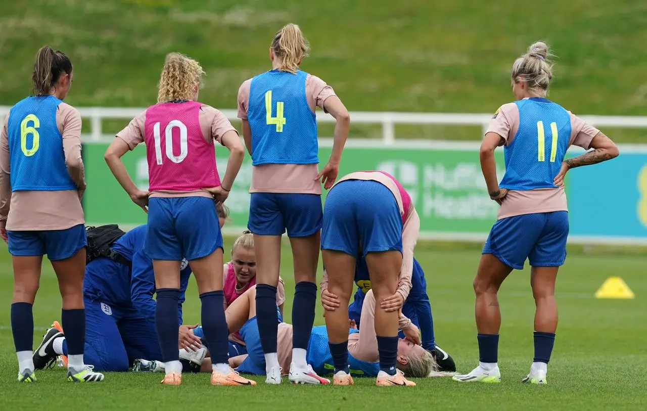 Alex Greenwood receives treatment on the pitch during England's training session on Tuesday