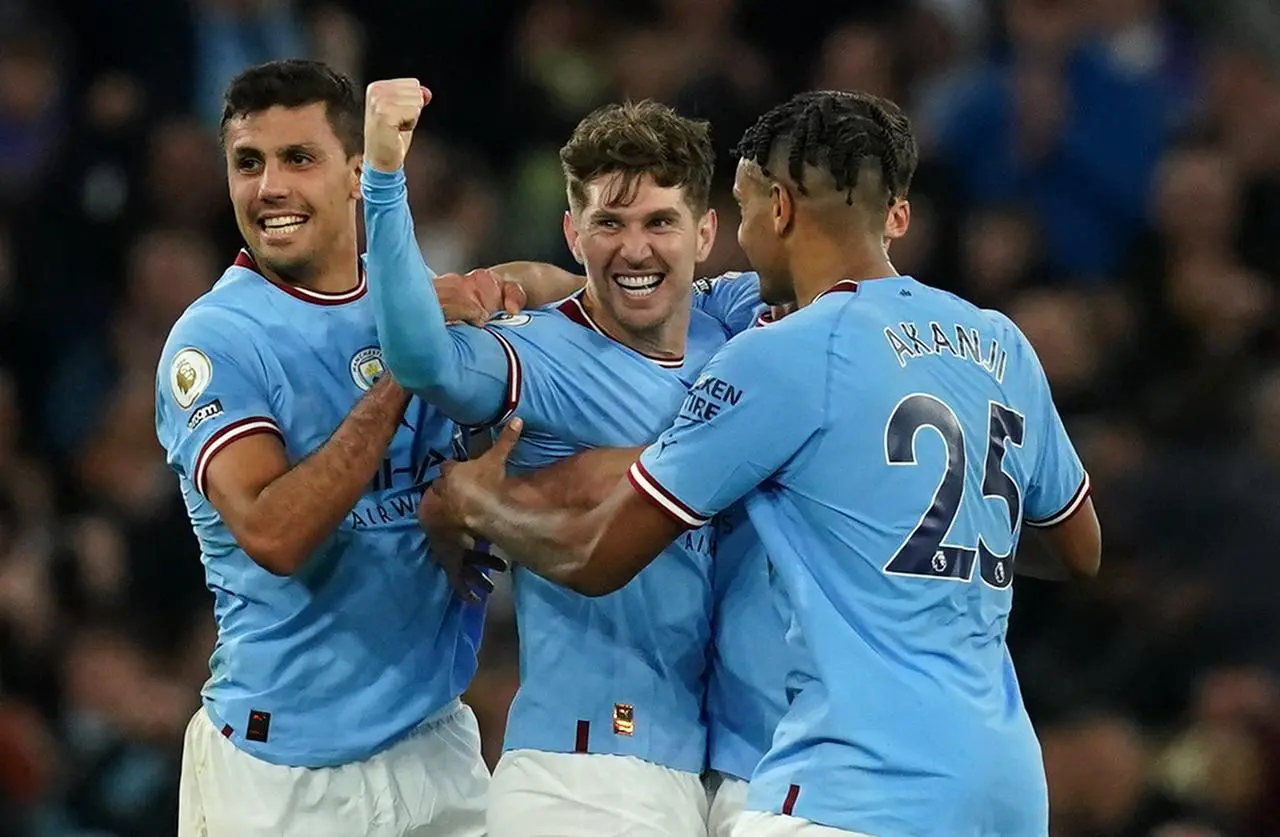 John Stones (centre) celebrates scoring against Arsenal