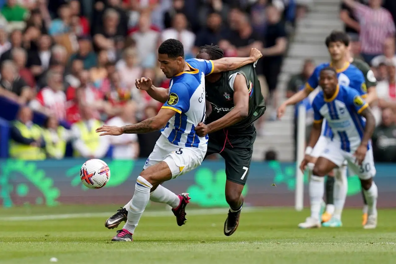 Levi Colwill, playing on loan for Brighton, holds off Southampton's Joe Aribo