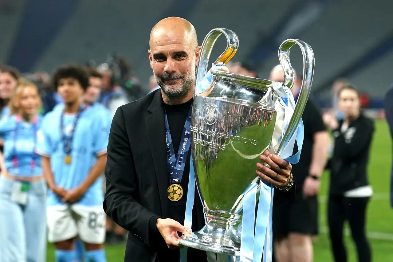 Pep Guardiola celebrates with the Champions League trophy