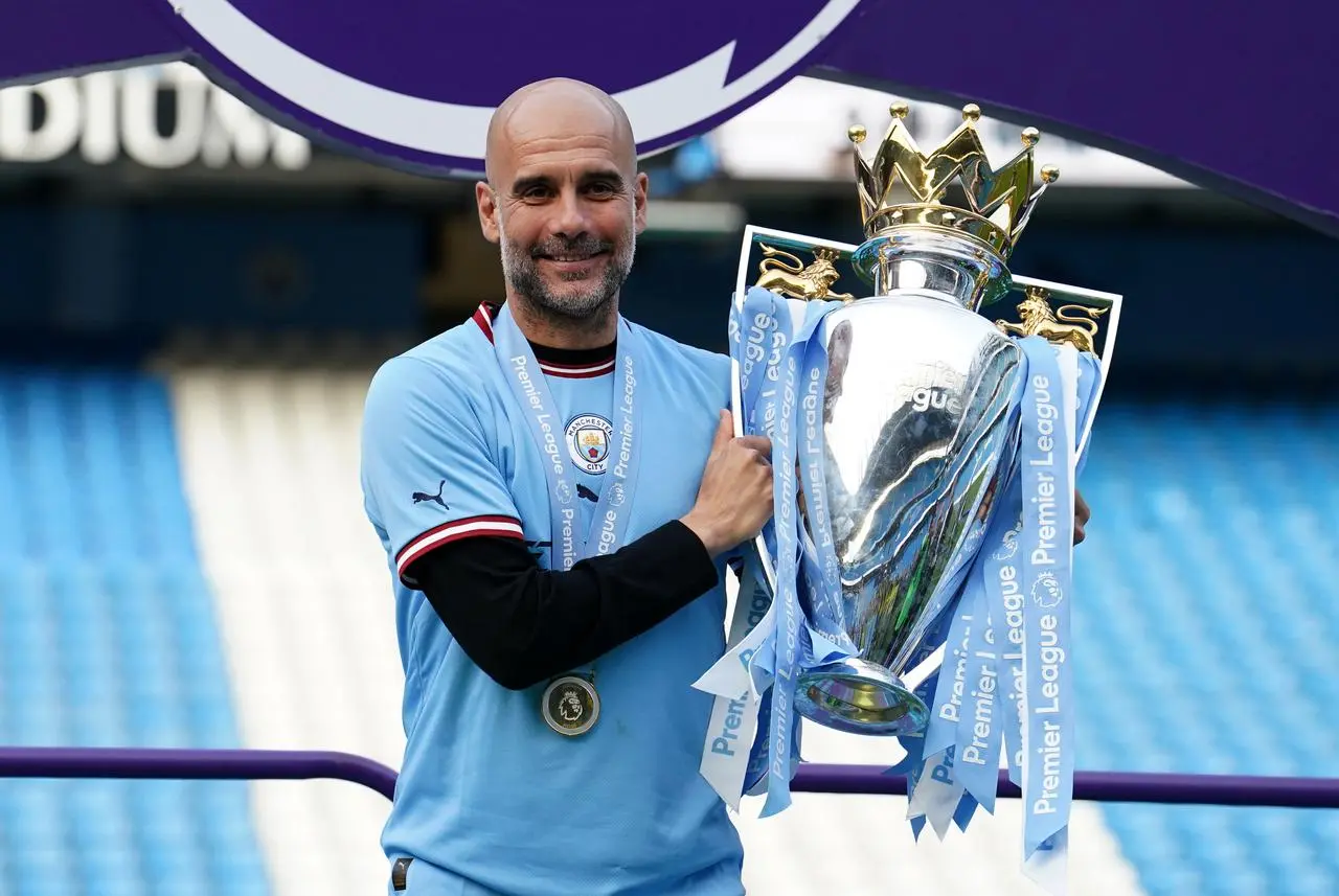 Pep Guardiola lifts the Premier League trophy