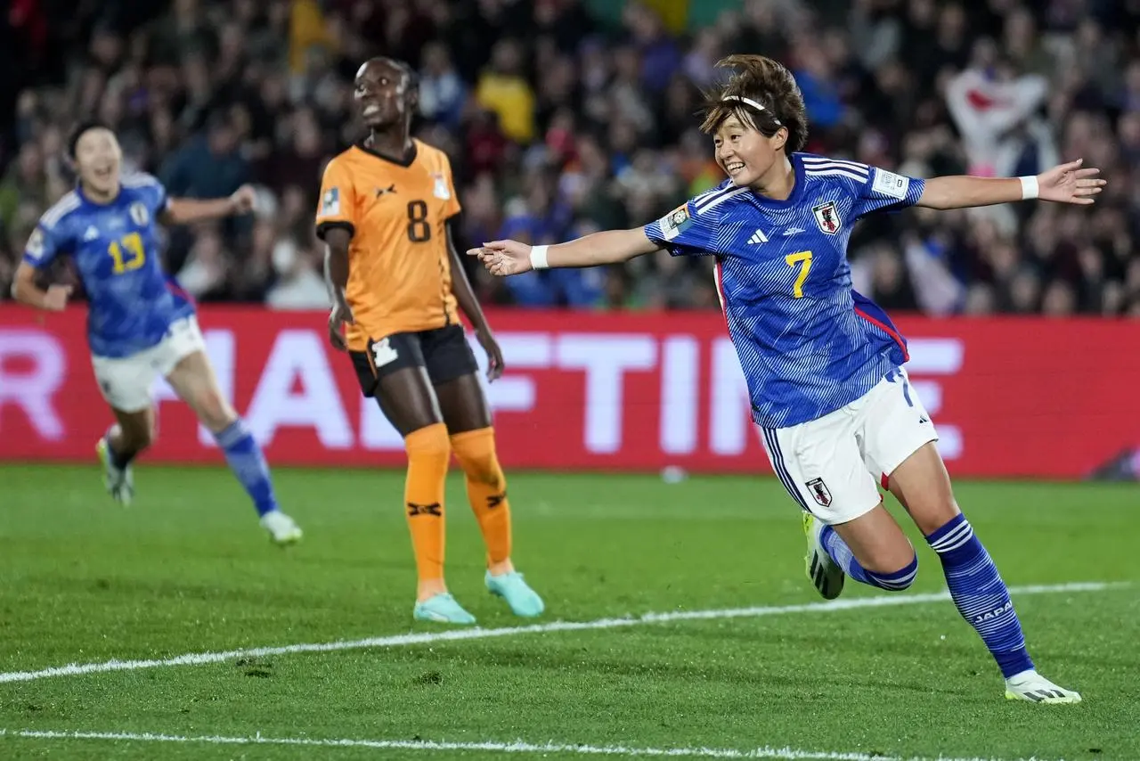 Japan's Hinata Miyazawa, right, celebrates after scoring against Zambia