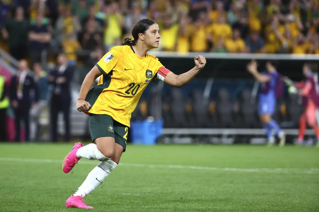 Sam Kerr celebrates after scoring her shoot-out penalty against France