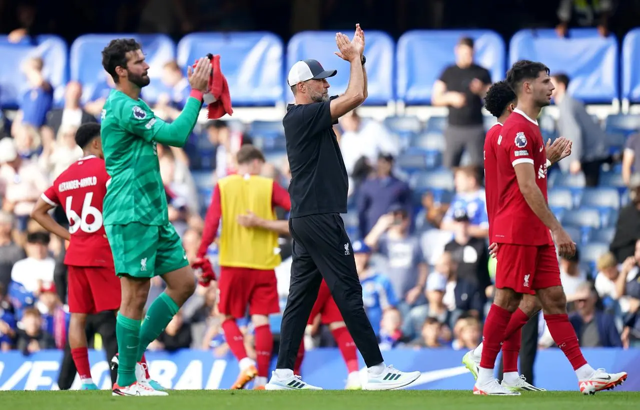 Jurgen Klopp, centre, and his team applaud the fans after the final whistle