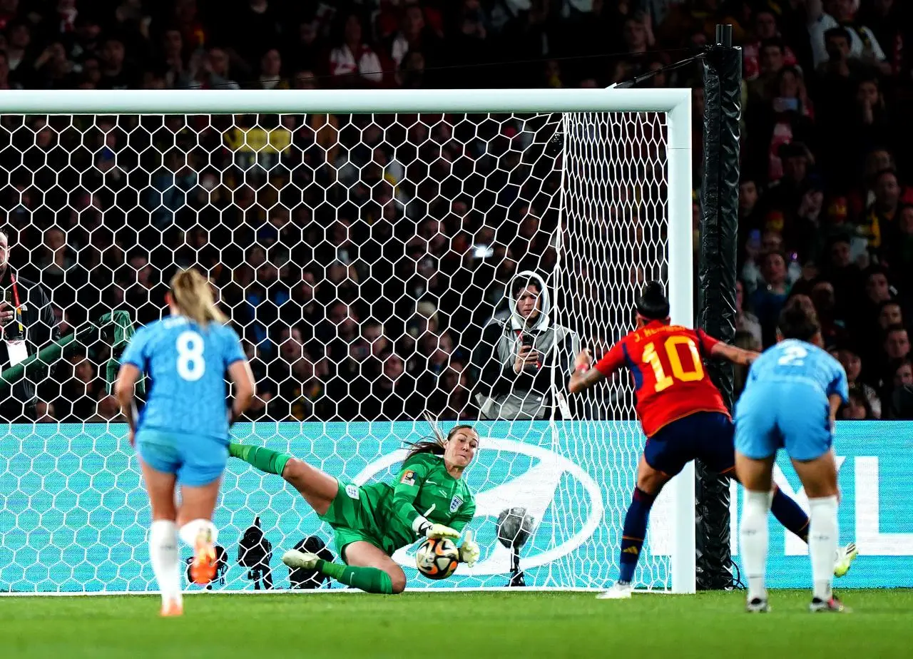 England goalkeeper Mary Earps, centre, saves a penalty from Spain's Jennifer Hermoso, second right, in the final