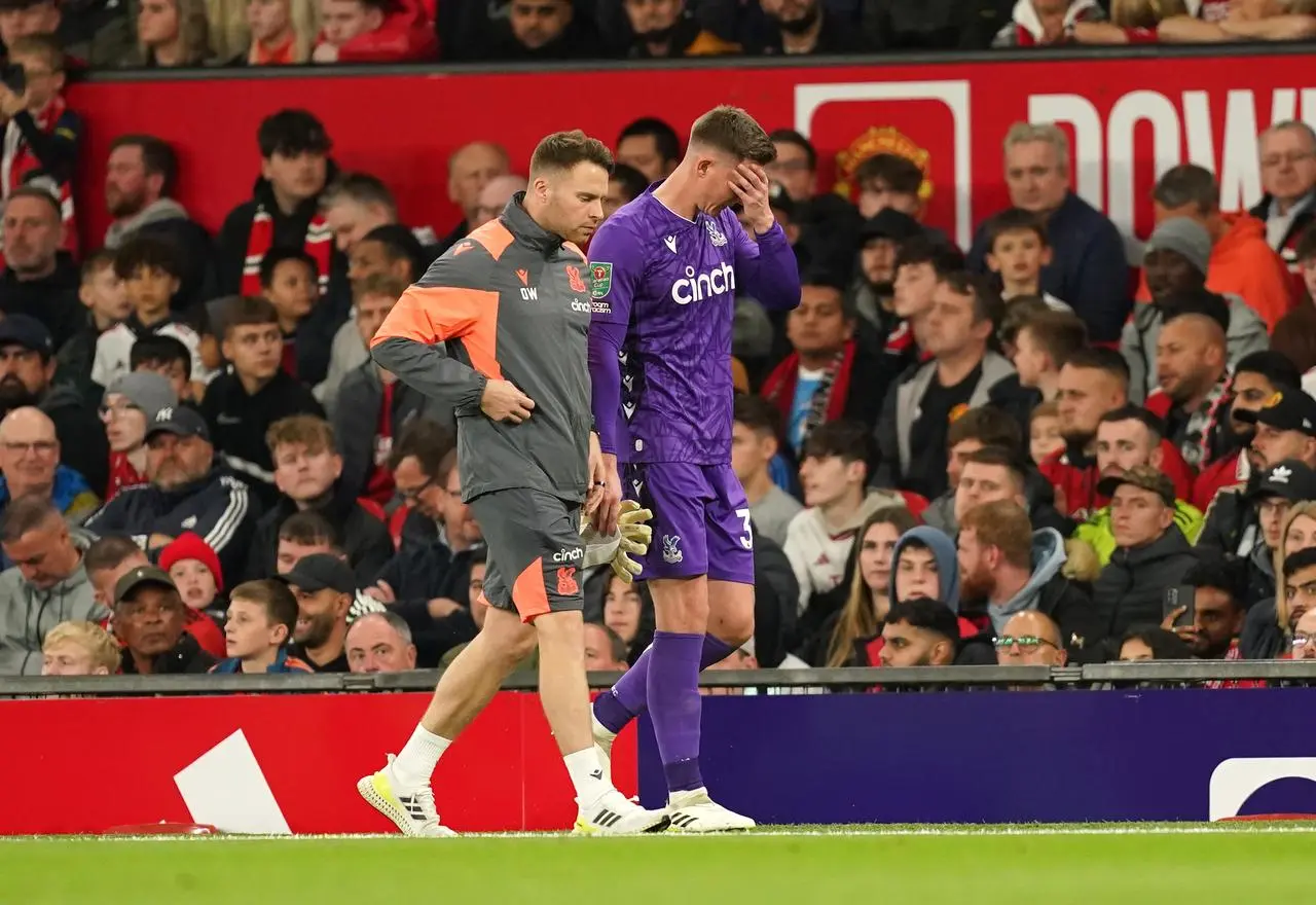 Dean Henderson, right, limps off at Old Trafford