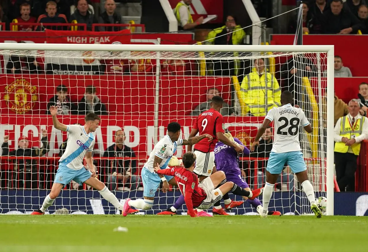 Alejandro Garnacho, centre, stretches to score Manchester United’s first goal against Crystal Palace