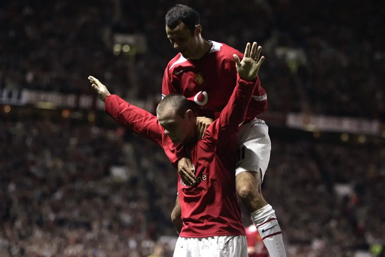 Ryan Giggs jumps on Wayne Rooney's back after his hat-trick goal Ryan Giggs jumps on Wayne Rooney’s back after his hat-trick goal 