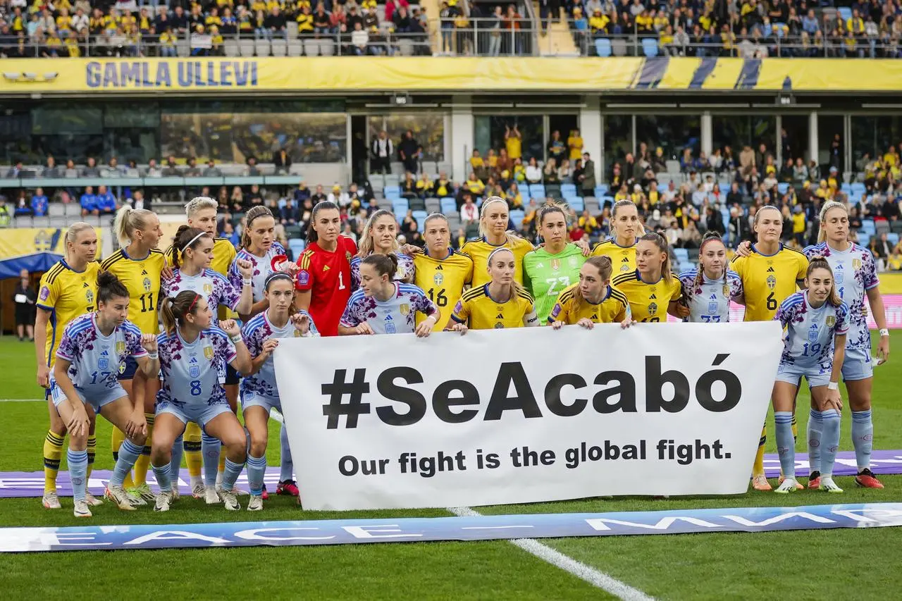 Spain and Sweden players hold a banner reading ‘#SeAcabó – Our fight is the global fight’ before their recent Nations League match