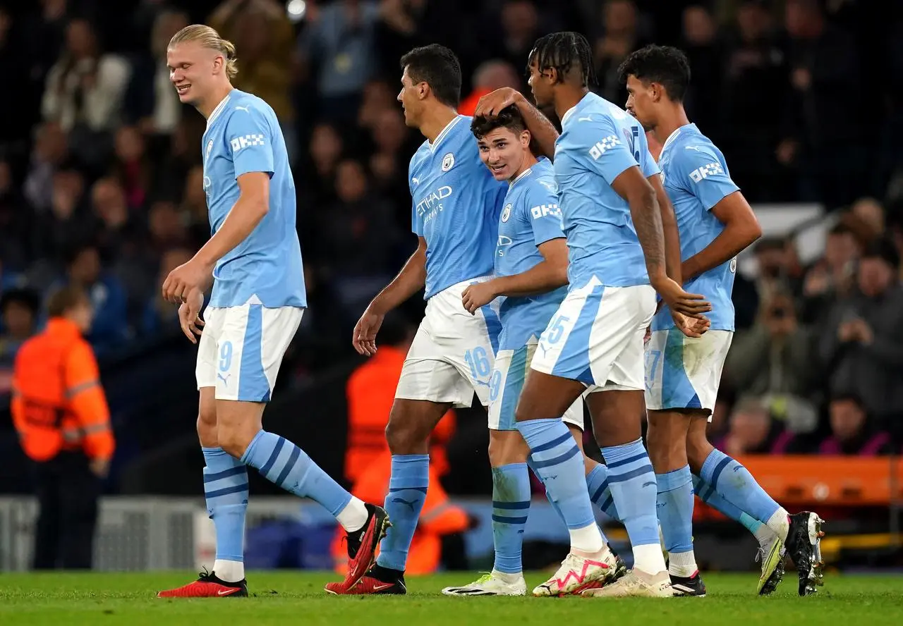 Rodri, second left, congratulates fellow goalscorer Julian Alvarez, centre