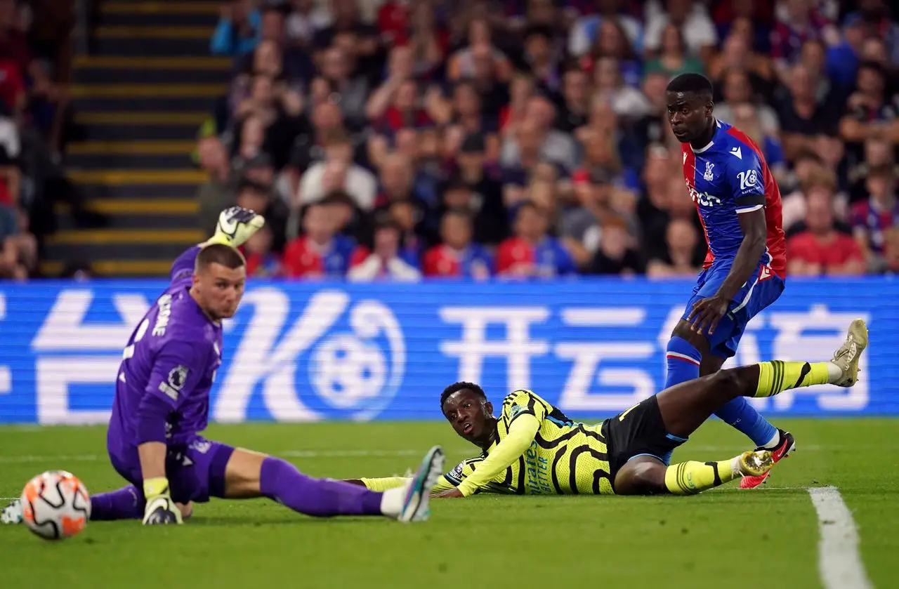 Arsenal's Eddie Nketiah, centre, shoots at goal under pressure from Crystal Palace's Sam Johnstone, left, and Marc Guehi