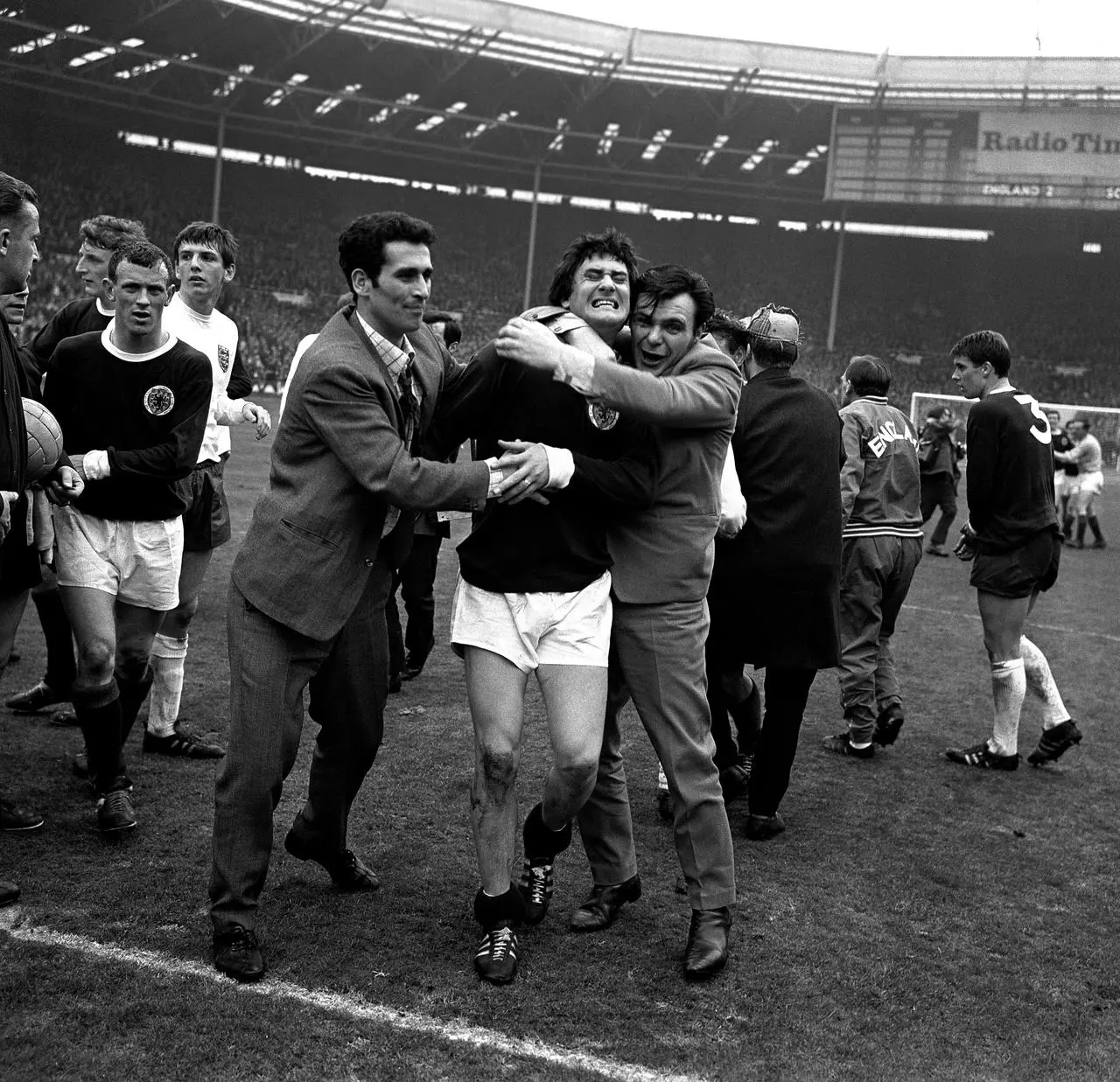 Scotland fans hug Jim Baxter