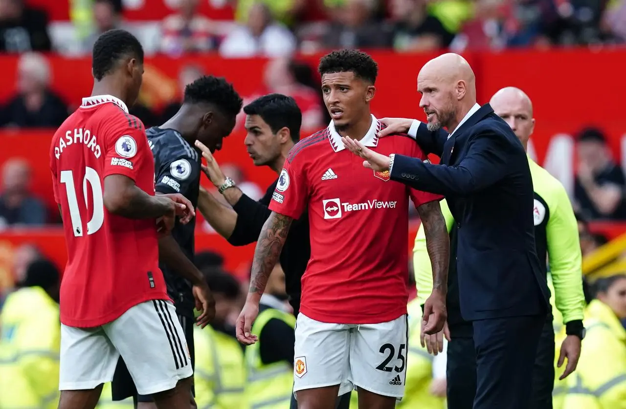 Erik ten Hag talks to Jadon Sancho