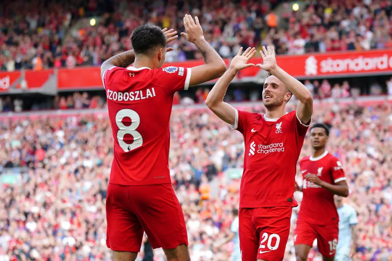 Dominik Szoboszlai celebrates with Diogo Jota