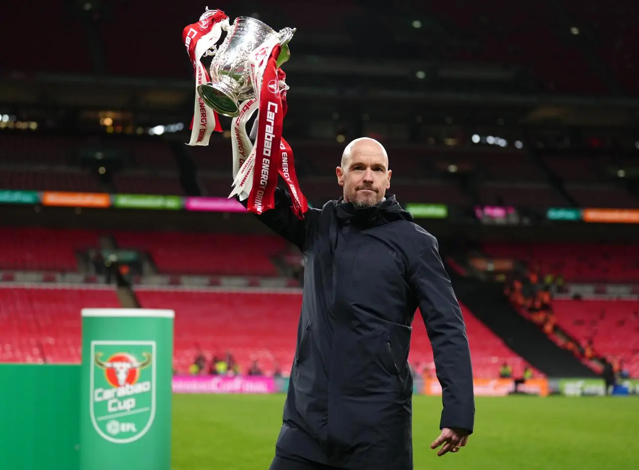 Manchester United manager Erik ten Hag lifts the Carabao Cup aloft