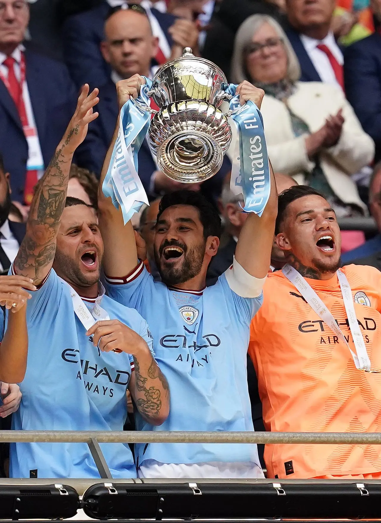 Ilkay Gundogan, alongside Kyle Walker and Ederson, lifts the FA Cup