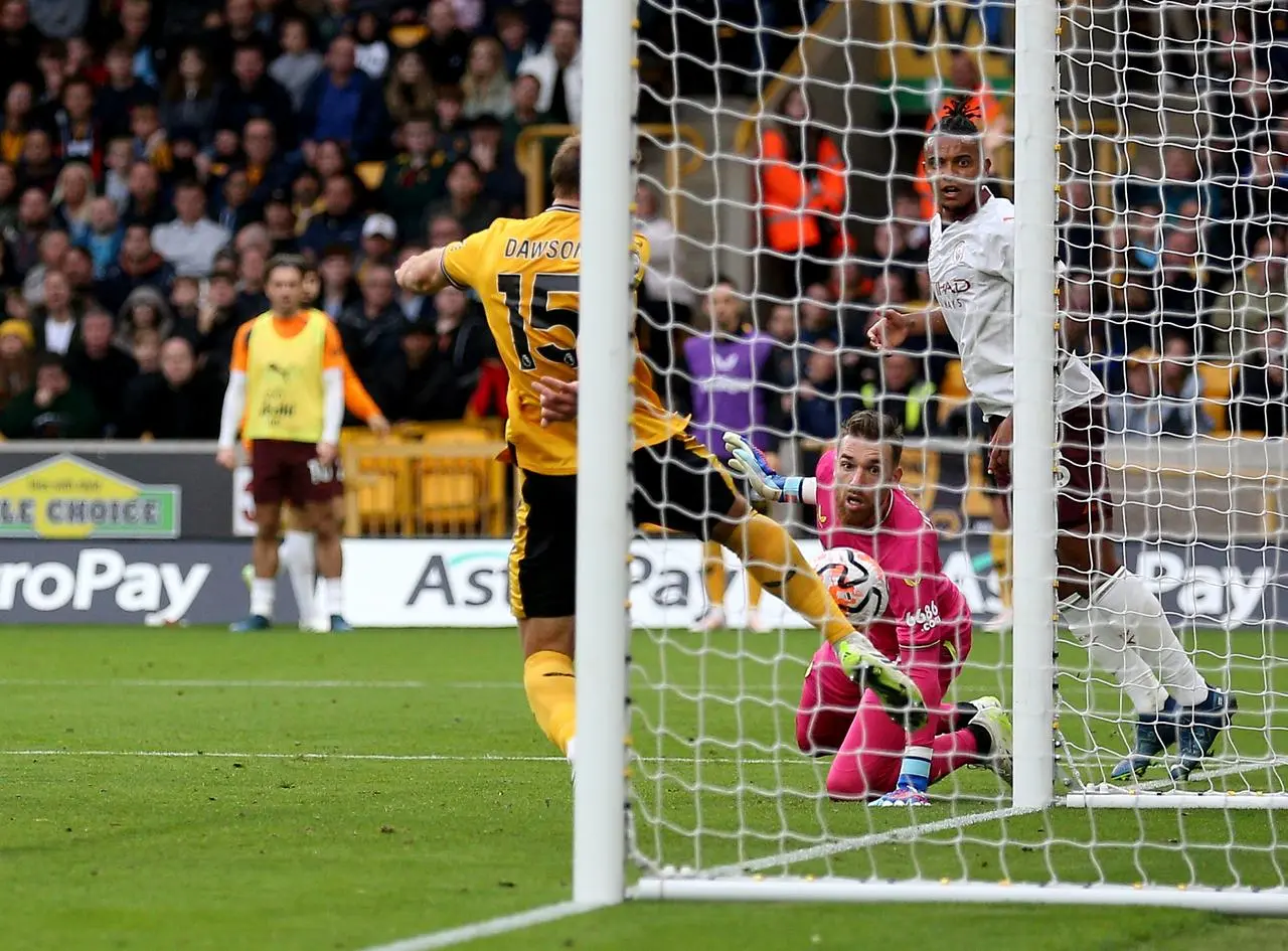 Craig Dawson clears a Phil Foden effort off the line