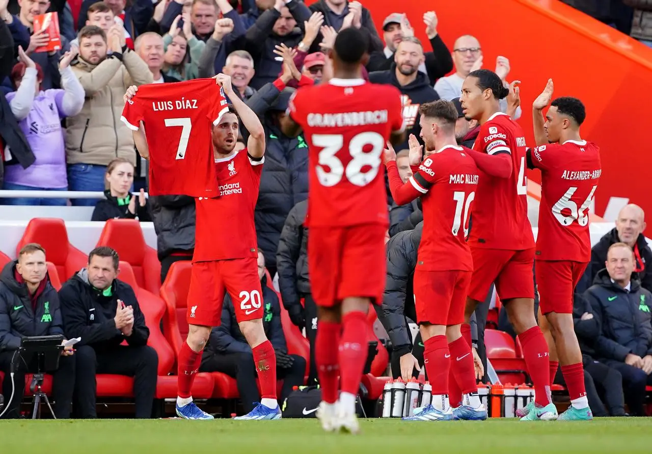 Liverpool’s Diogo Jota celebrates a goal by displaying Luis Diaz’s shirt