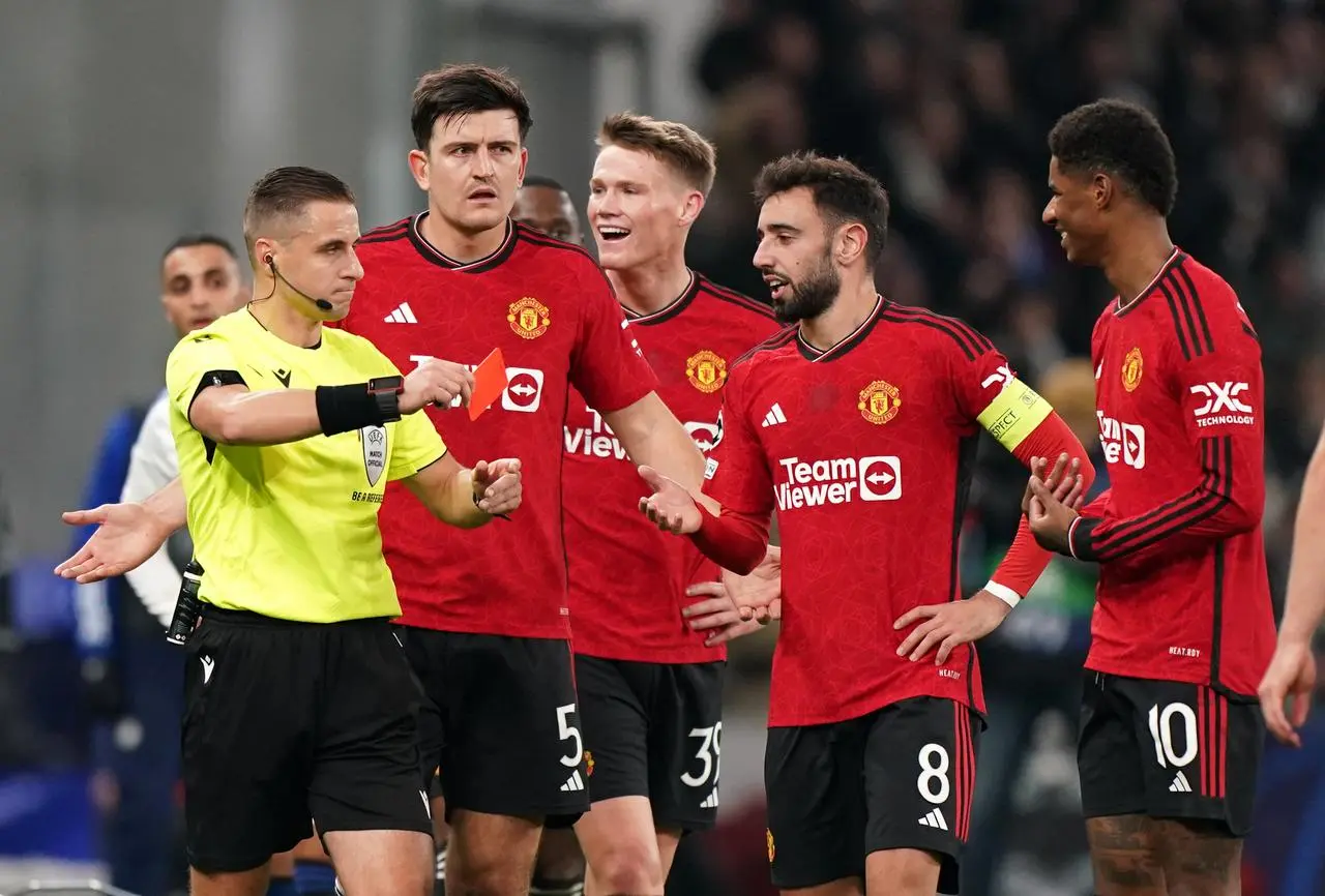 Marcus Rashford (right) is shown a red card