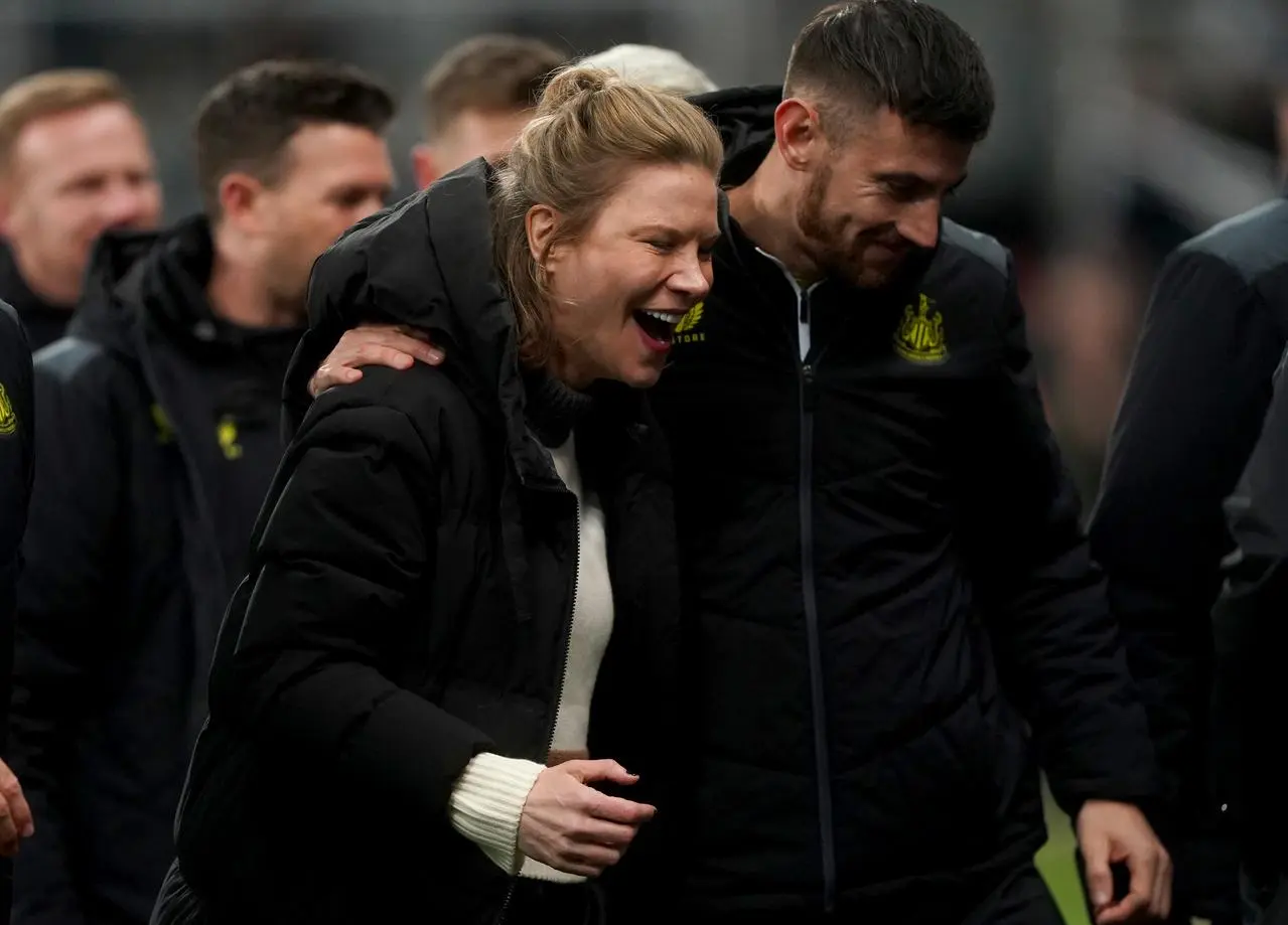 Newcastle co-owner Amanda Staveley celebrates on the pitch after the win