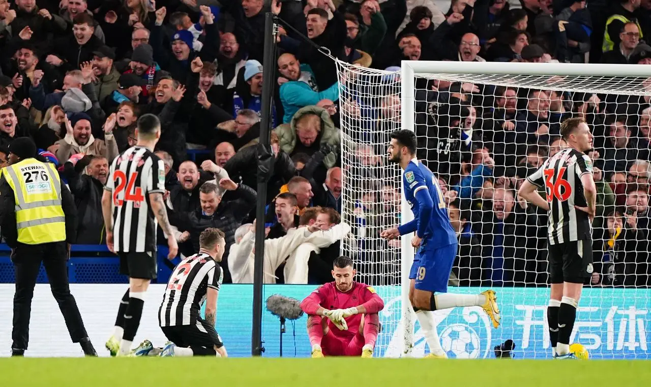 Newcastle's Kieran Trippier, centre left, and Martin Dubravka are left dejected on the ground after Chelsea’s equaliser