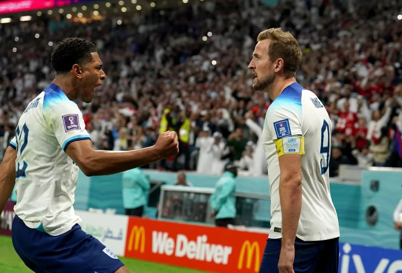 Harry Kane, right, celebrates a goal with Jude Bellingham