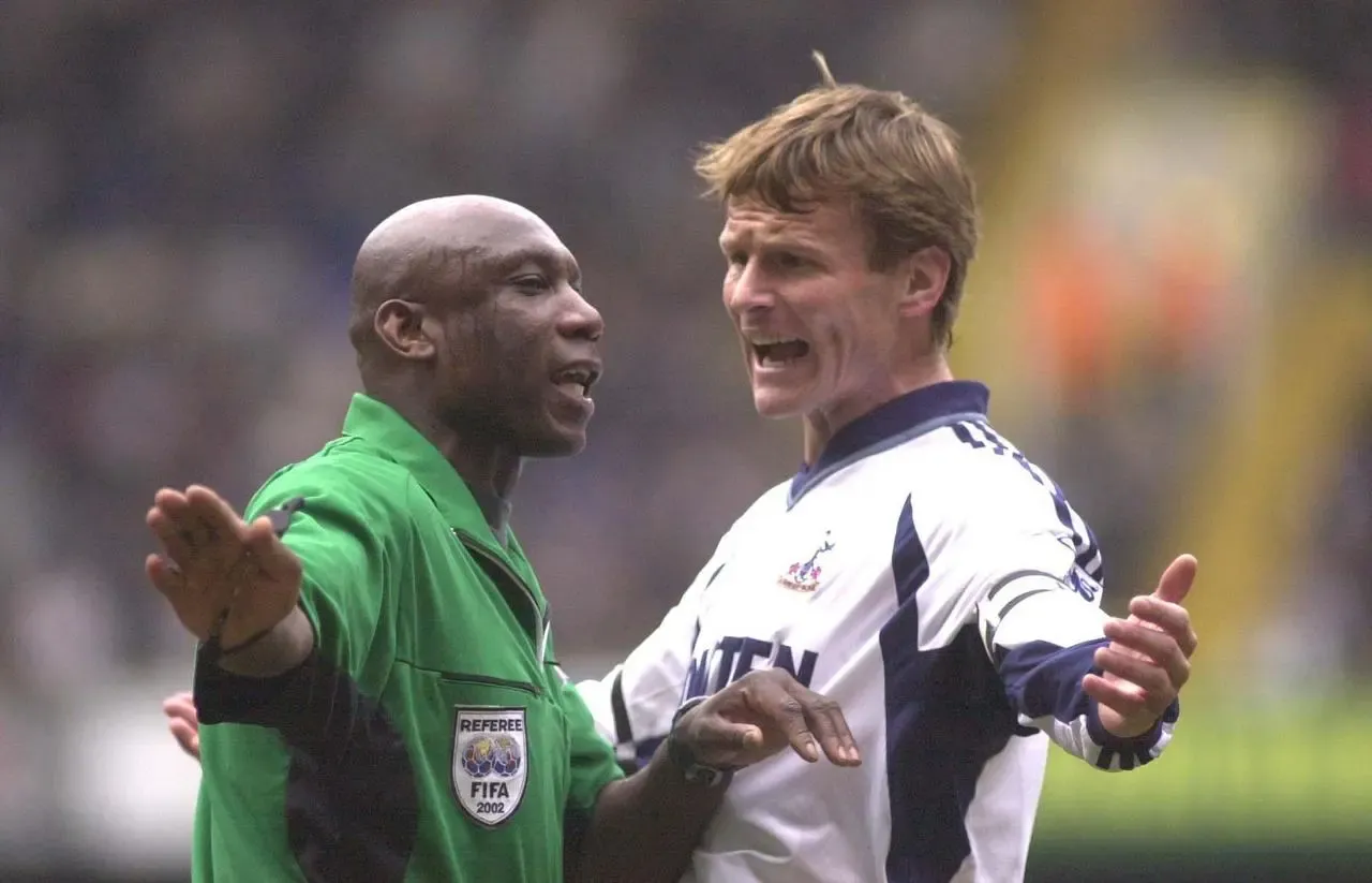Tottenham striker Teddy Sheringham has a word with referee Uriah Rennie