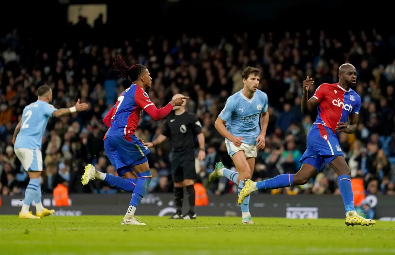 Michael Olise celebrates his equaliser against Manchester City