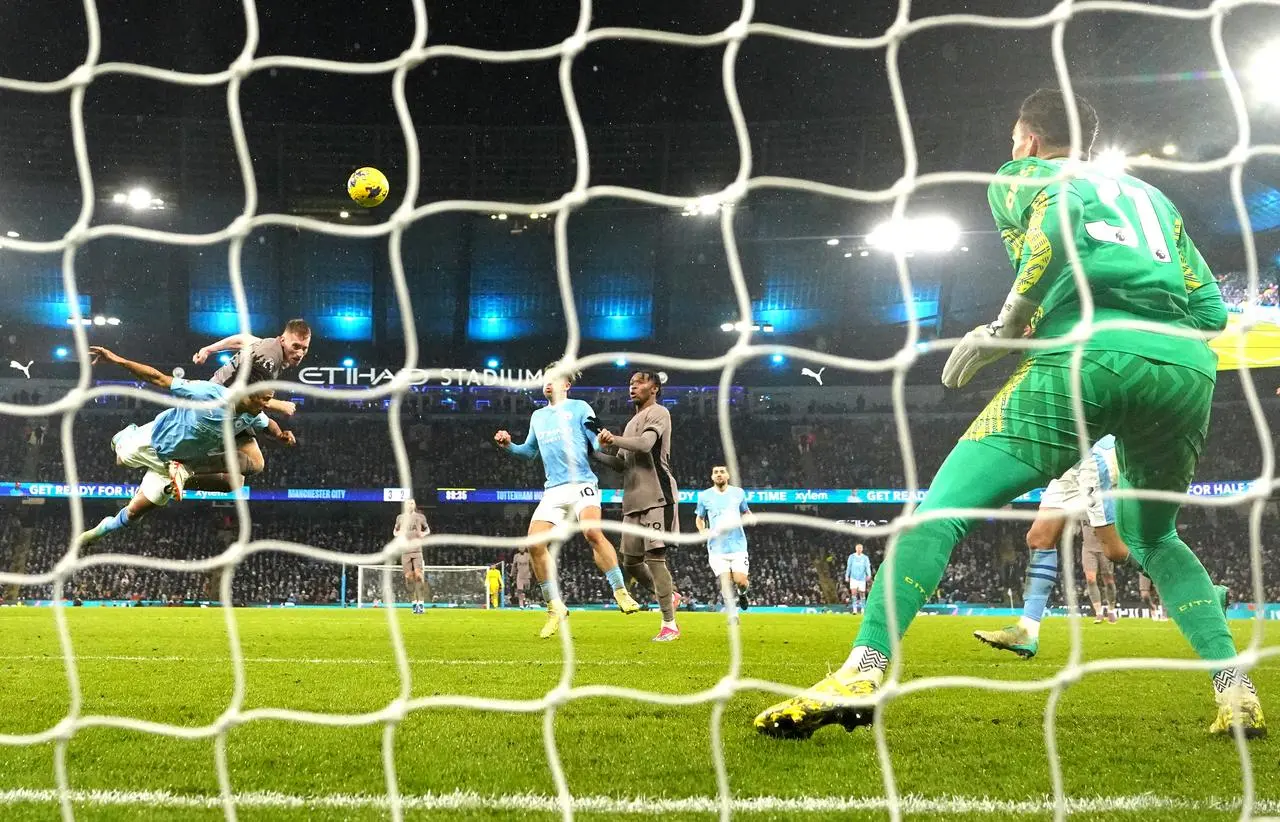 Dejan Kulusevski, second left, scores for Tottenham against Manchester City