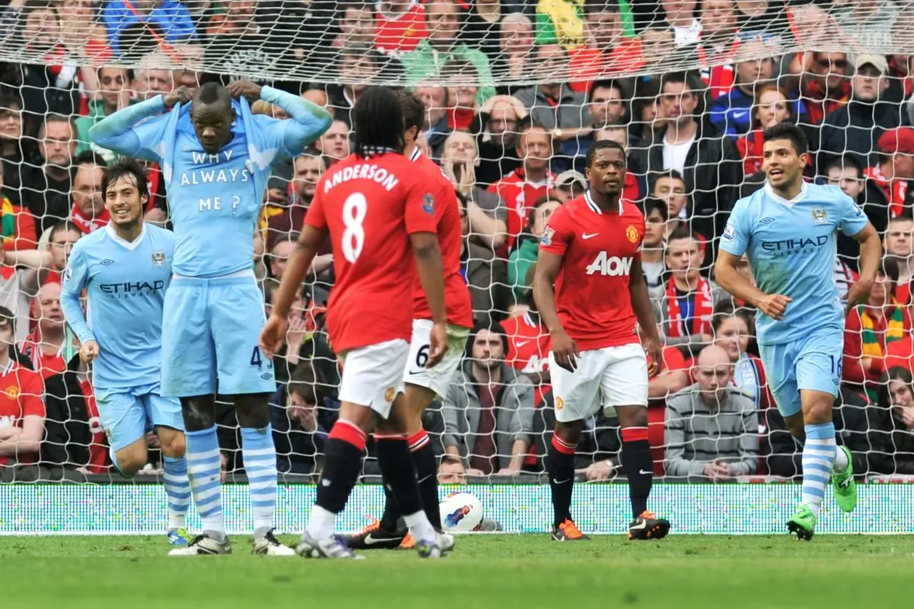 Mario Balotelli, second left, celebrates with a 'Why Always Me?' T-shirt after scoring at Old Trafford in 2011