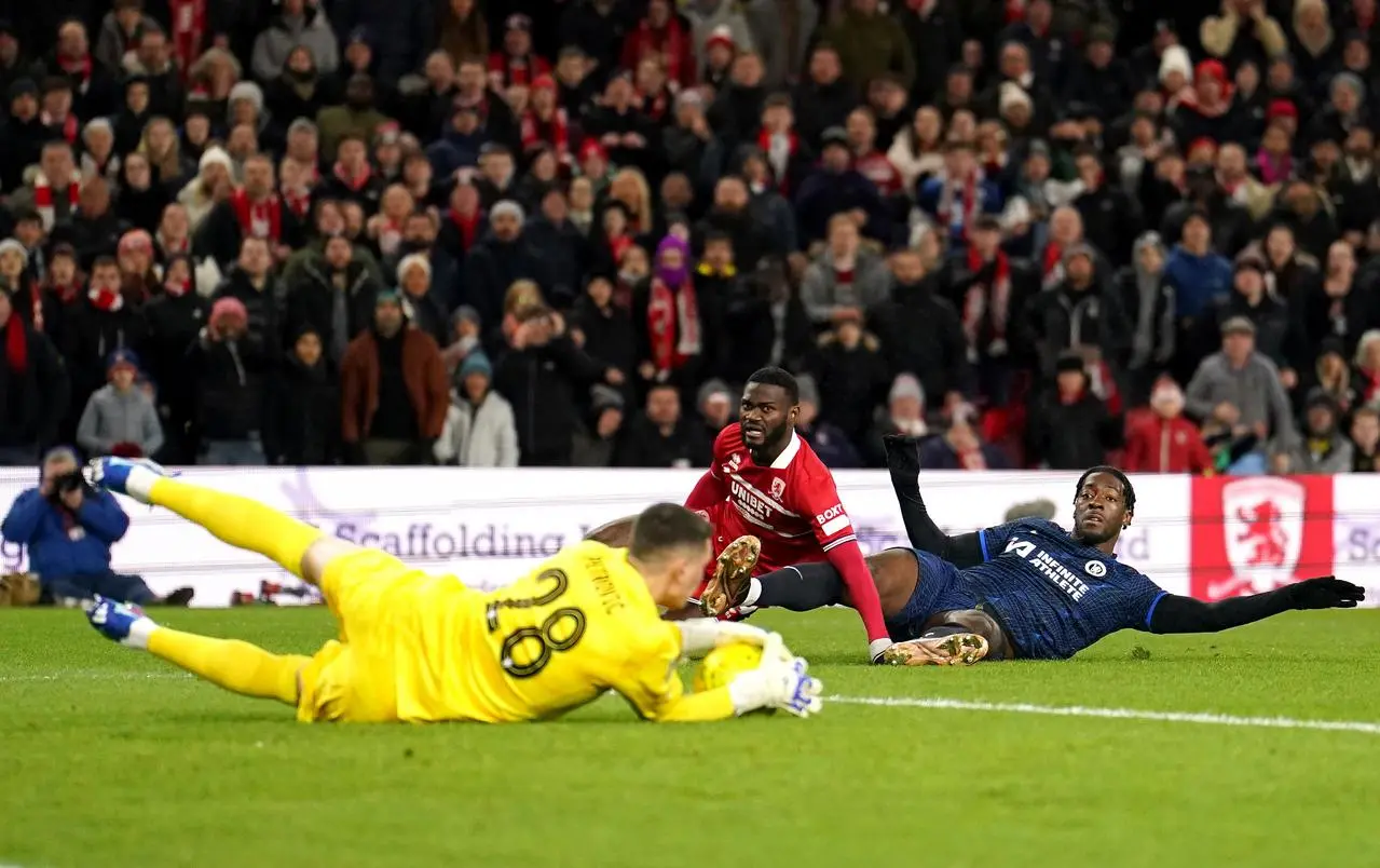 Middlesbrough's Emmanuel Latte Lath, centre, sees his shot saved by Chelsea goalkeeper Djordje Petrovic, left