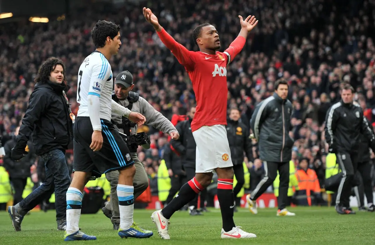 Manchester United defender Patrice Evra (right) and Liverpool striker Luis Suarez 