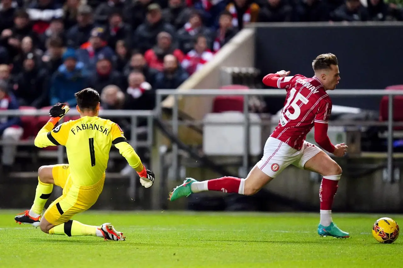 Tommy Conway, right, goes round goalkeeper Lukasz Fabianski before scoring Bristol City's winner