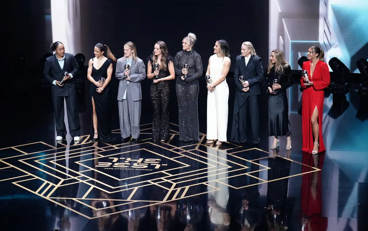 Players on stage collect the Women's World XI trophy