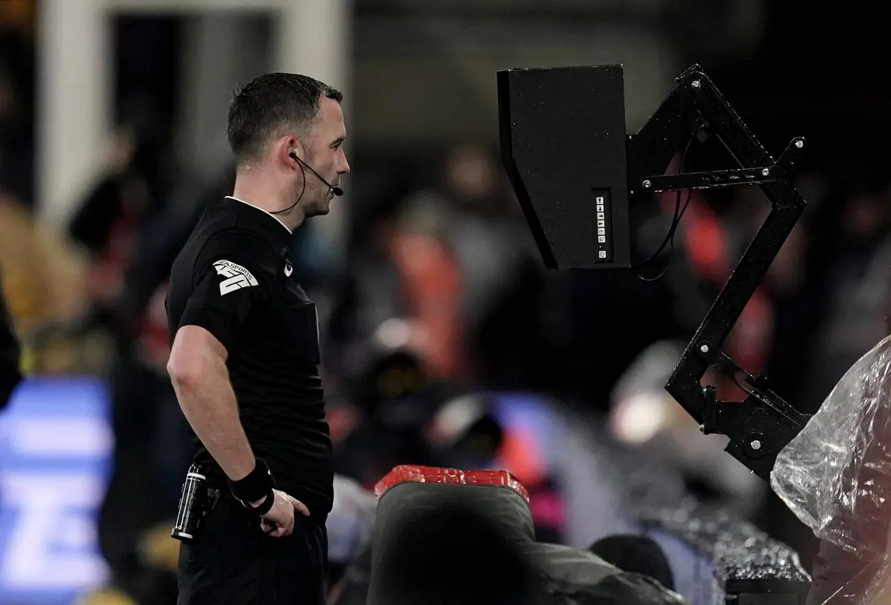 Chris Kavanagh views the VAR monitor before sending off Dominic Calvert-Lewin