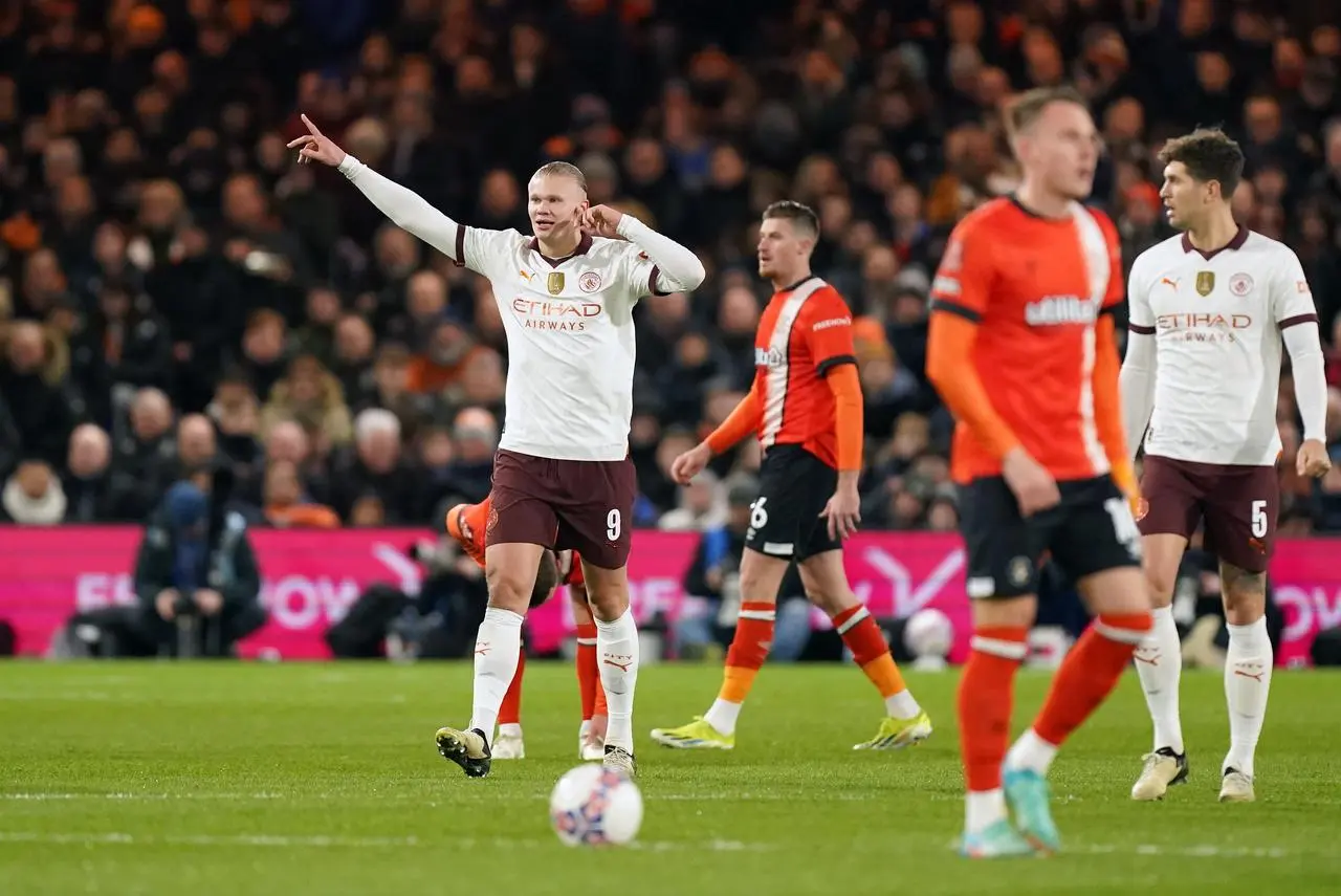 Erling Haaland, left, celebrates after scoring Manchester City's first goal at Luton