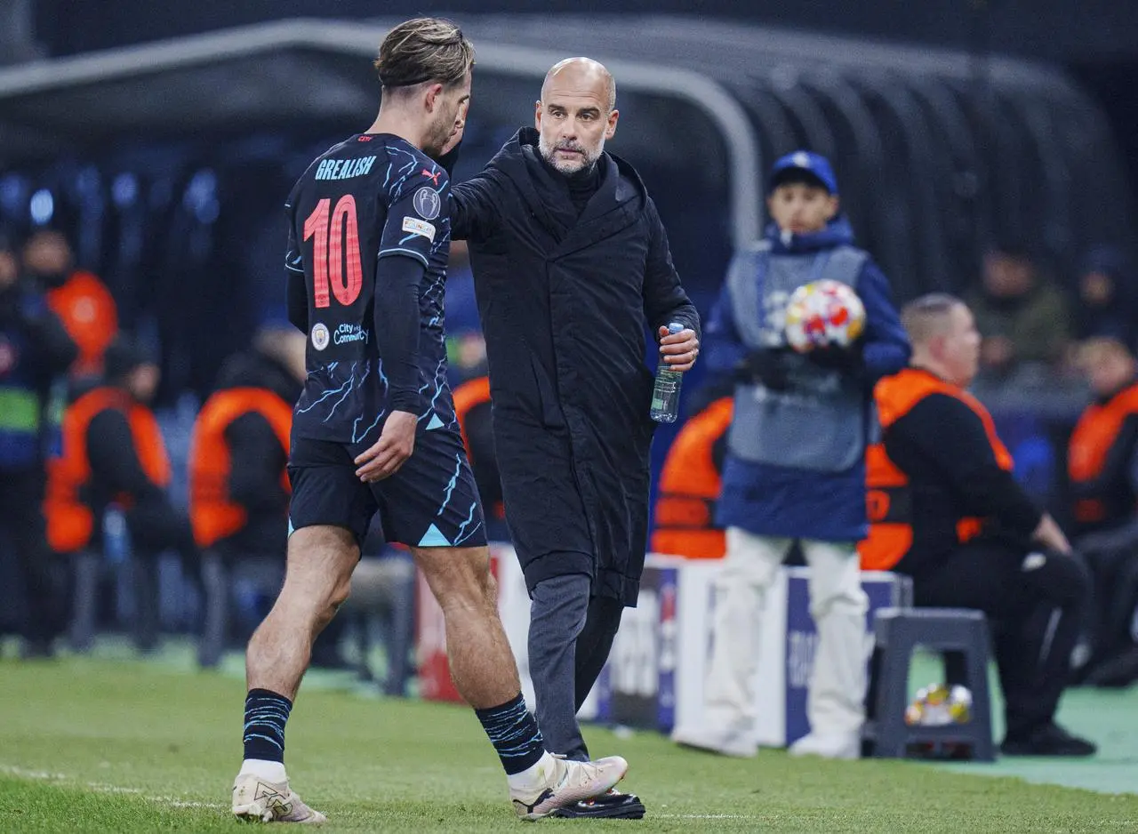 Pep Guardiola greets Jack Grealish, left, as he is substituted against FC Copenhagen