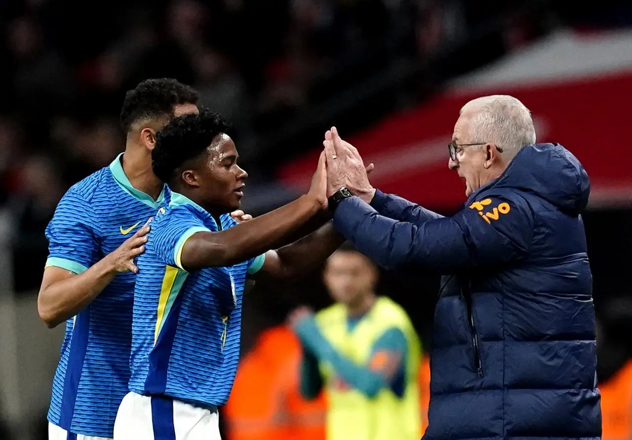 Endrick is congratulated by his manager Dorival Junior, right, after scoring the winner at Wembley